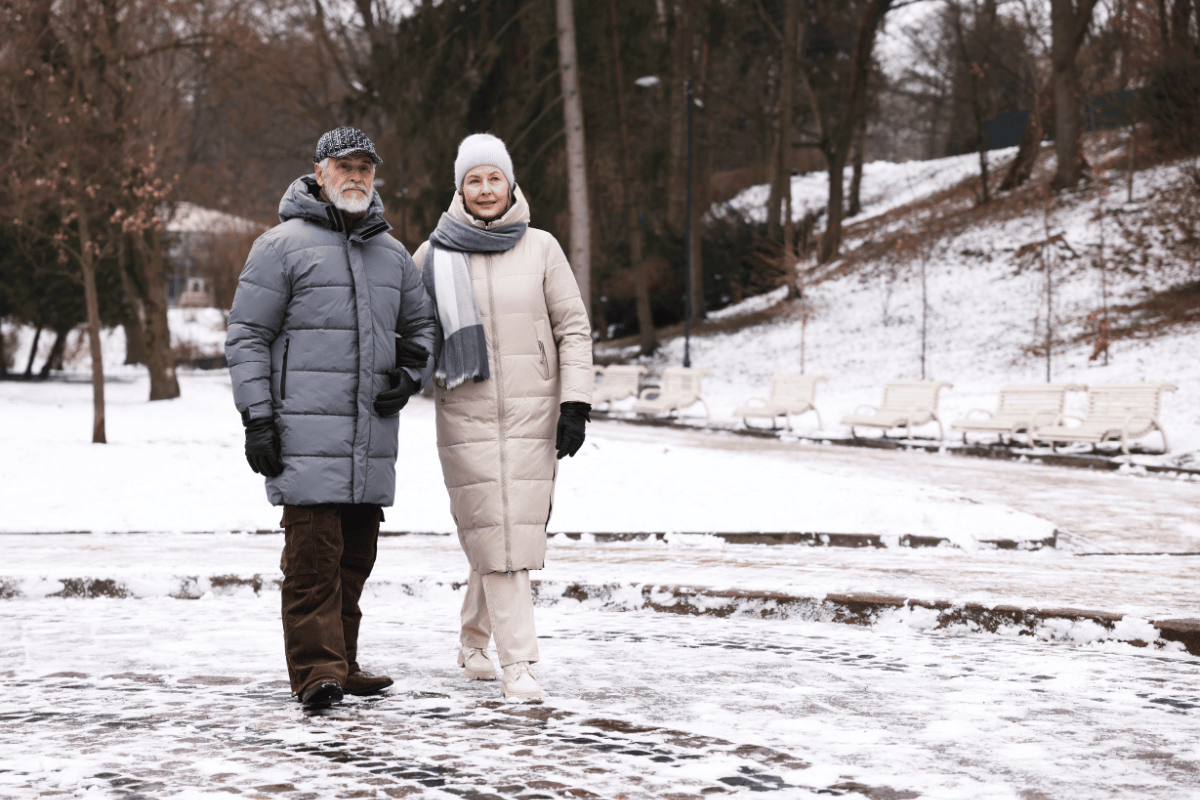 Senior couple walking in snowy weather