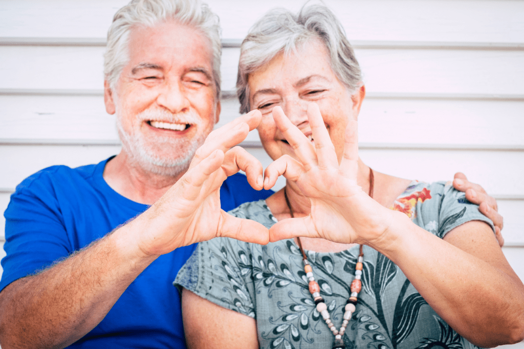 couple making heart symbol with hands