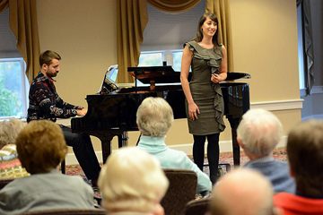 woman singing opera in front of a piano