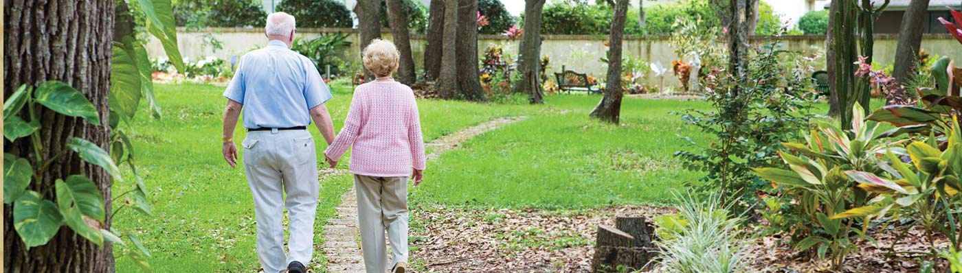 older couple walking the grounds at Eddy Senior Living community