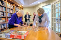 Beverwyck residents doing a puzzle in the library