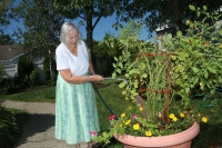 Marjorie Doyle Rockwell Center resident watering plants