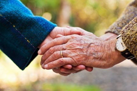 Close up of a woman's hands holding a child's hand