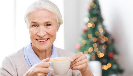 Woman smiling holding a coffee cup