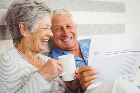 Seniors looking at a paper considering Assisted Living