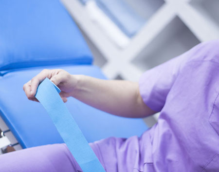 Physical therapists holding blue tape