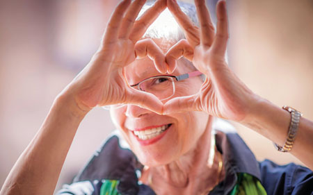 Woman making a heart shape with her fingers