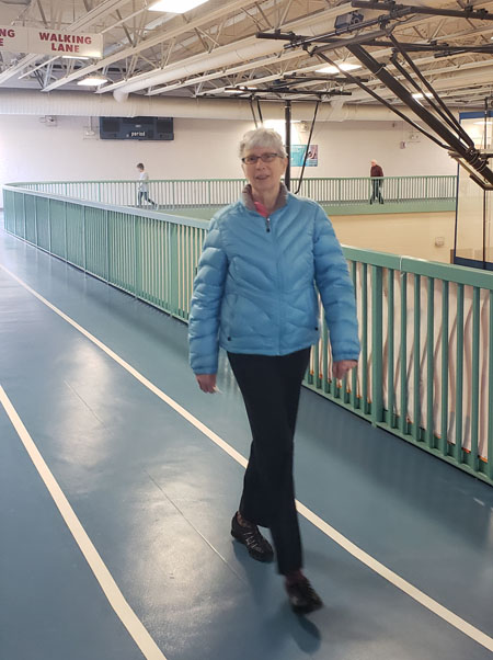 Senior woman walking on an indoor track