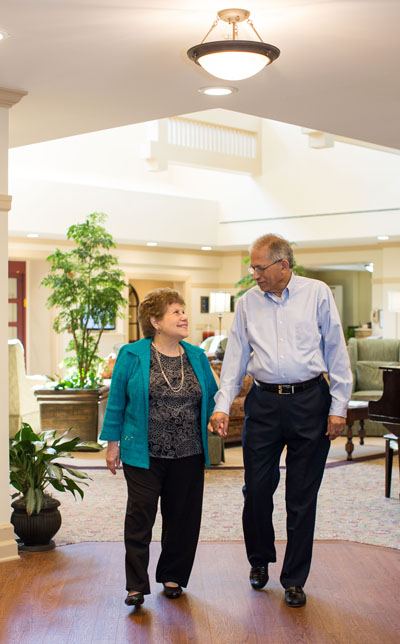 Seniors walking holding hands