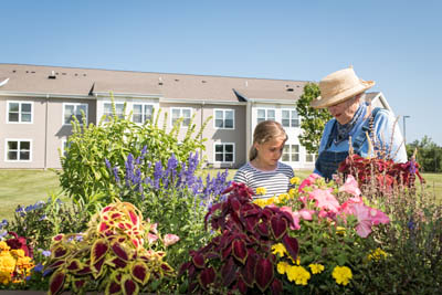 Senior gardening with granddaughter