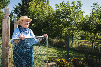 Senior standing by a fence