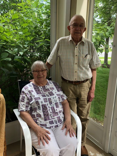 Marion sitting and ken standing next to her