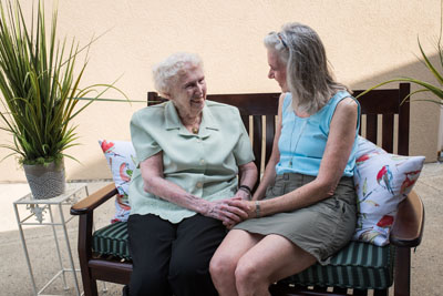 Two senior women friends conversing