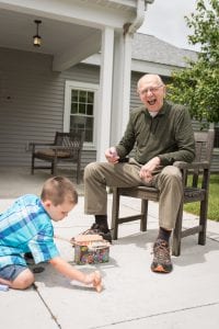 resident watching grandson play