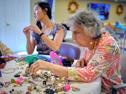 Senior woman with trinkets on table