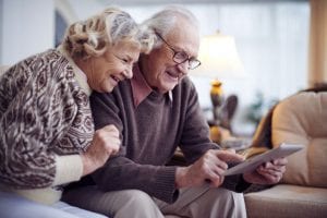 Senior couple networking at home