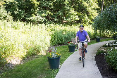 Senior man riding bike with helmet