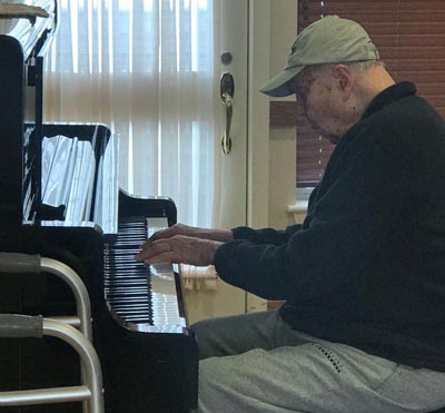 senior man playing piano