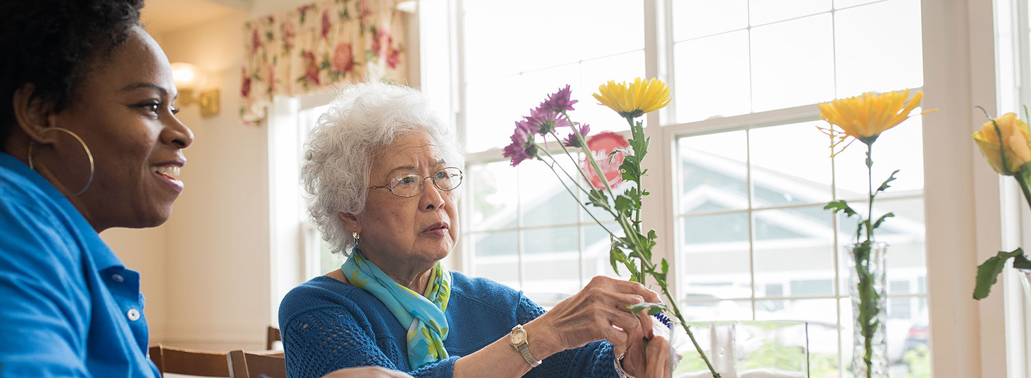 putting flowers in a vase