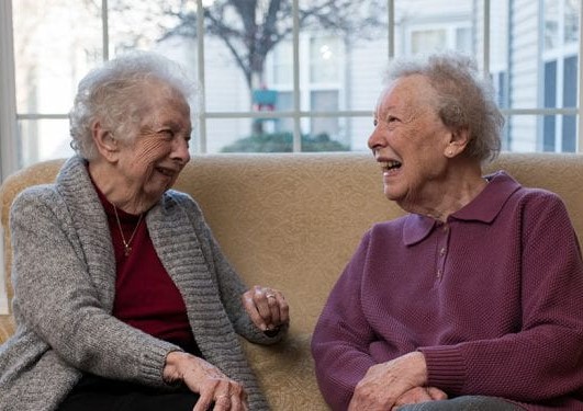 lady seniors laughing on couch