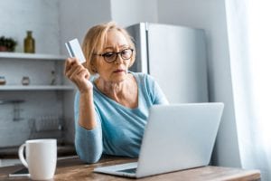 senior woman holding credit card