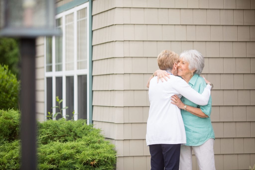 senior women embracing