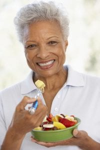 Senior eating fruit