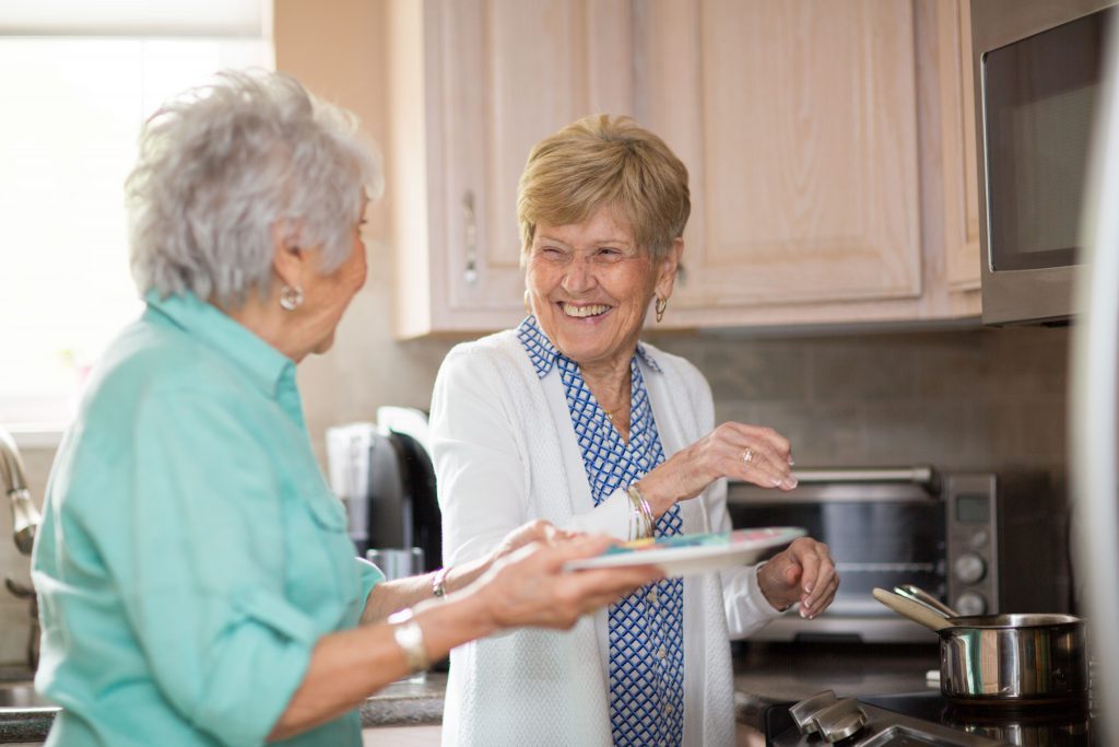 Friends laughing while cooking