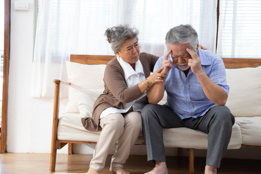 Senior Asian woman comforting her husband with dementia