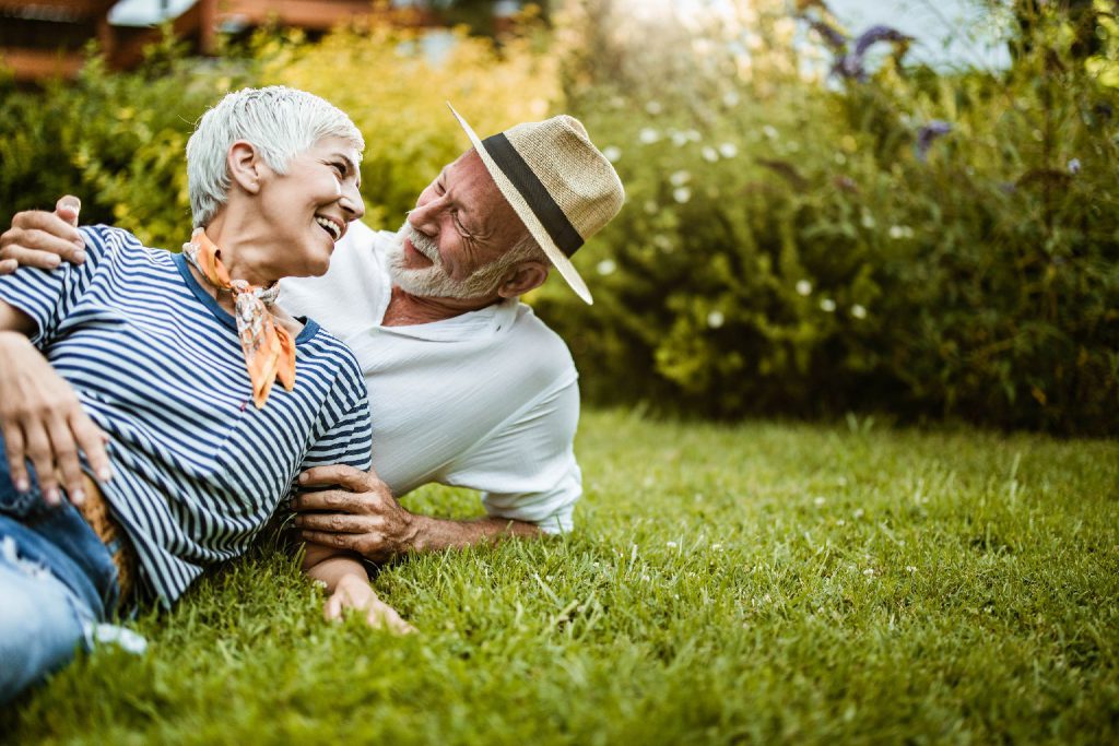 senior couple lying in grass